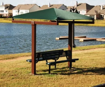 green shade over bench by lake